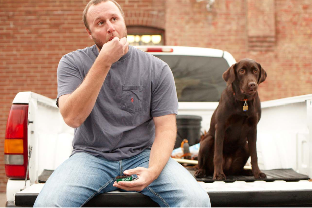 Dog and Man Using Timber Wolf Snuff Sitting In the Back of a Truck
